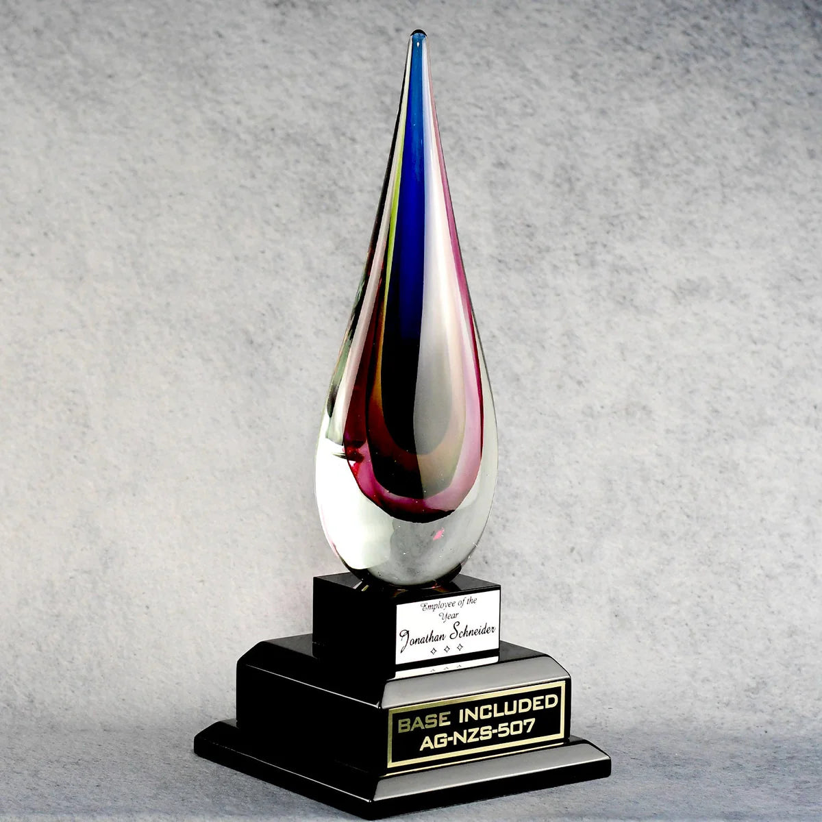 RAINBOW TEAR DROP ART GLASS AWARD WITH ENGRAVED PLATES ON EACH TIER.