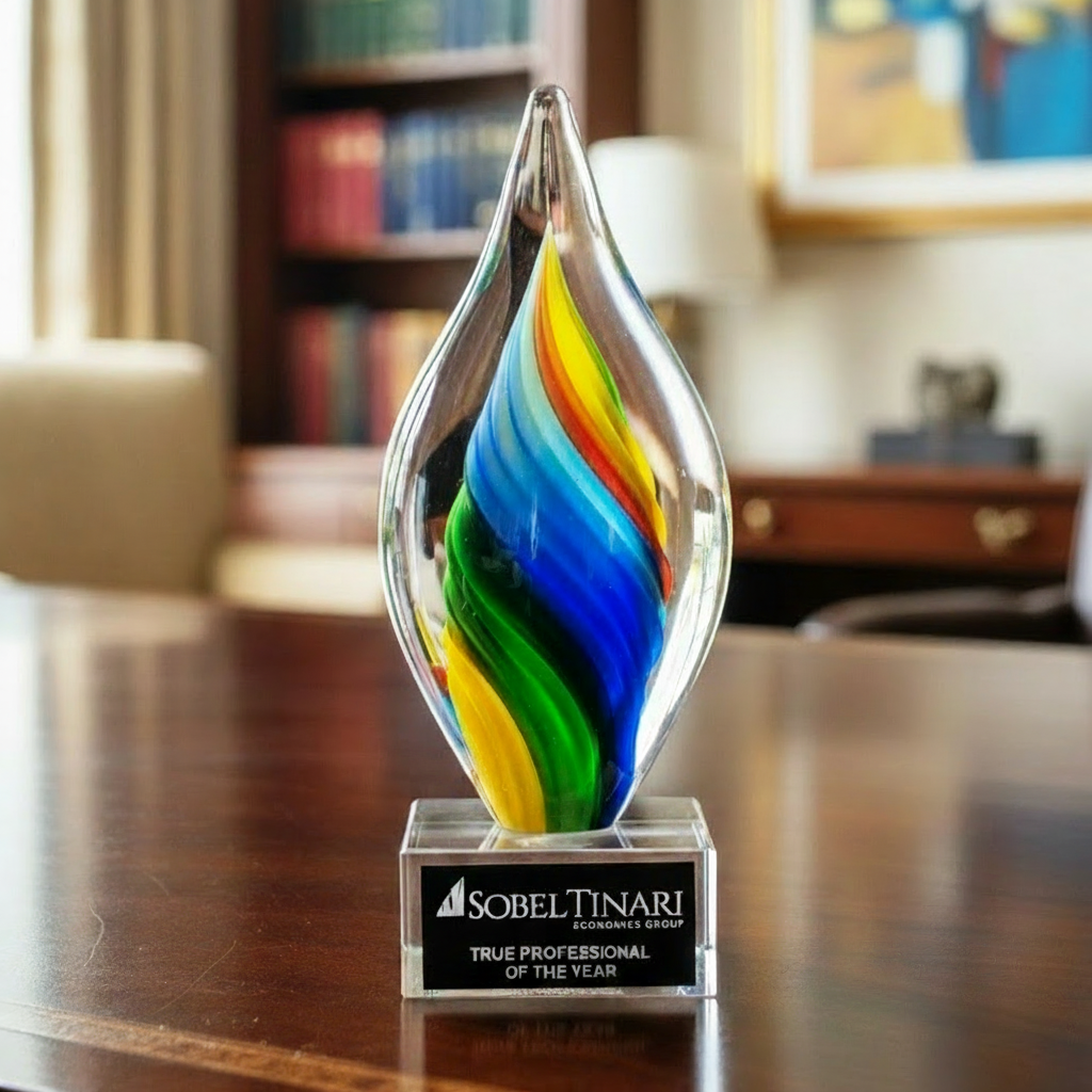 Colorful art glass award on a desk with blurred office background