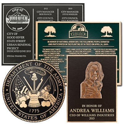 Three cast bronze plaques with text and images, including a memorial plaque for Andrea Williams, a city manager, and a historical marker for the City of Hood River.