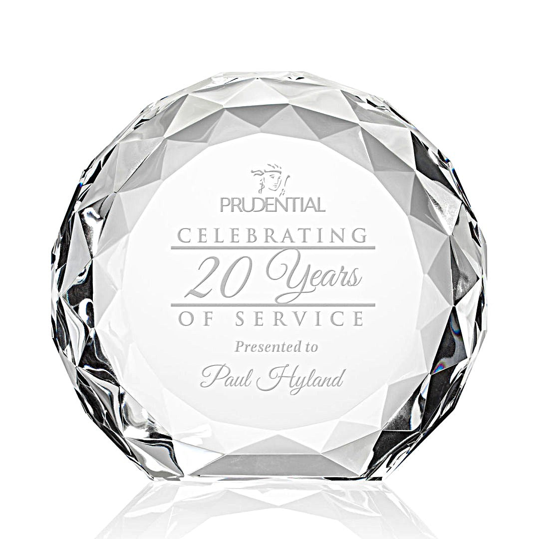 Stunning crystal awards with faceted surfaces, each engraved with recognition language such as 'Celebrating 20 Years of Service'.