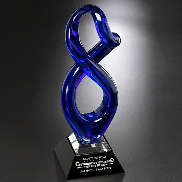 Blue Art Glass figure 8 Award with black marble base, sand etch engraving and white color fill,